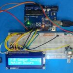 Assembled motion detection system using Arduino, PIR sensor, and LCD on a breadboard.